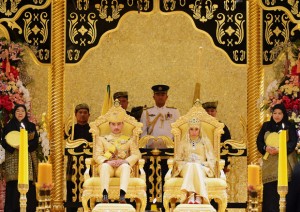 Brunei's newly wed royal couple, Prince Abdul Malik and Dayangku Raabi'atul 'Adawiyyah Pengiran Haji Bolkiah, sit during the "bersanding" or enthronement ceremony at their wedding in the Nurul Iman Palace in Bandar Seri Begawan
